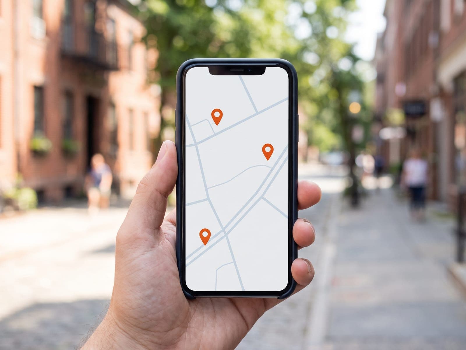Hand holding a phone showing a map with nearby business pins
